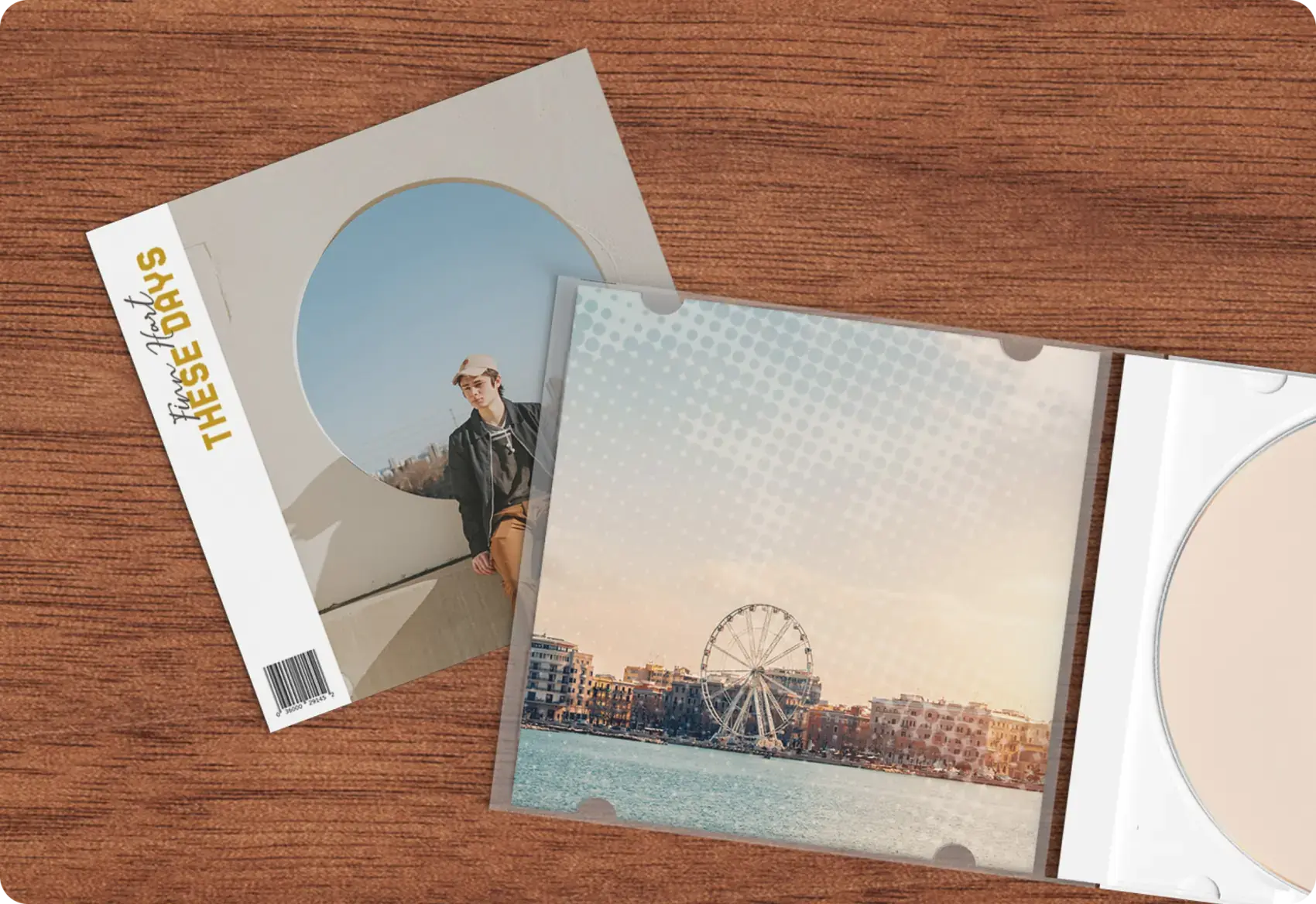 A CD album titled 'These Days' with a cover image of a person leaning against a wall and an open CD case showing an image of a Ferris wheel by the waterfront.